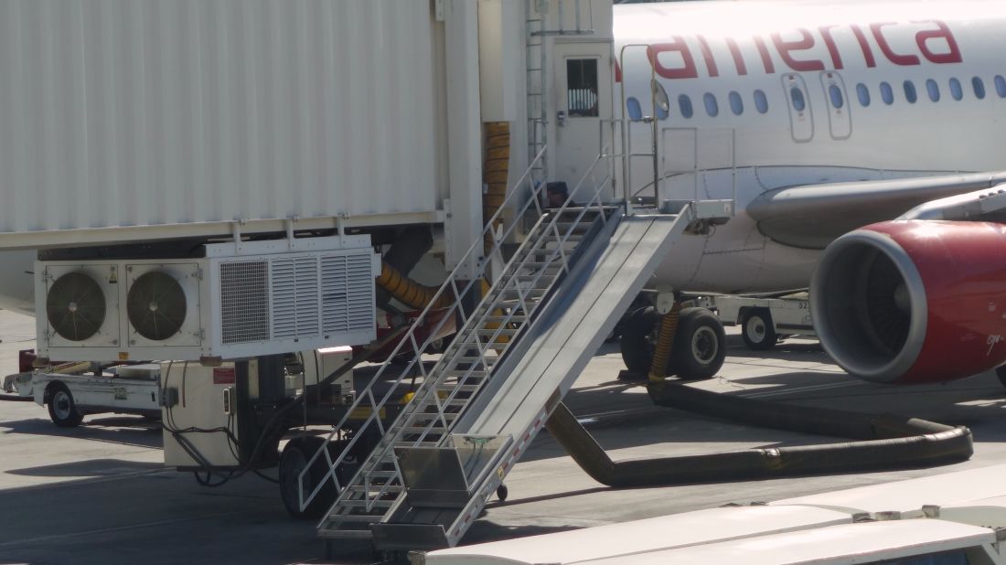 <strong>Plugged in: </strong>Ground power and air-conditioning equipment are fed into the aircraft's belly while it pauses for a breather on the ramp.<br />
