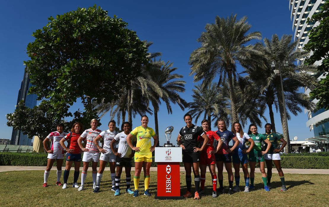 The World Rugby Sevens Series women's team captains pose with the Dubai Seven's Trophy.