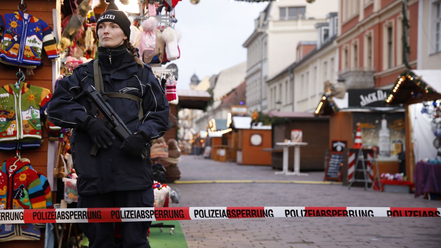 A police officer stands guard at the Potsdam Christmas market after it was evacuated.