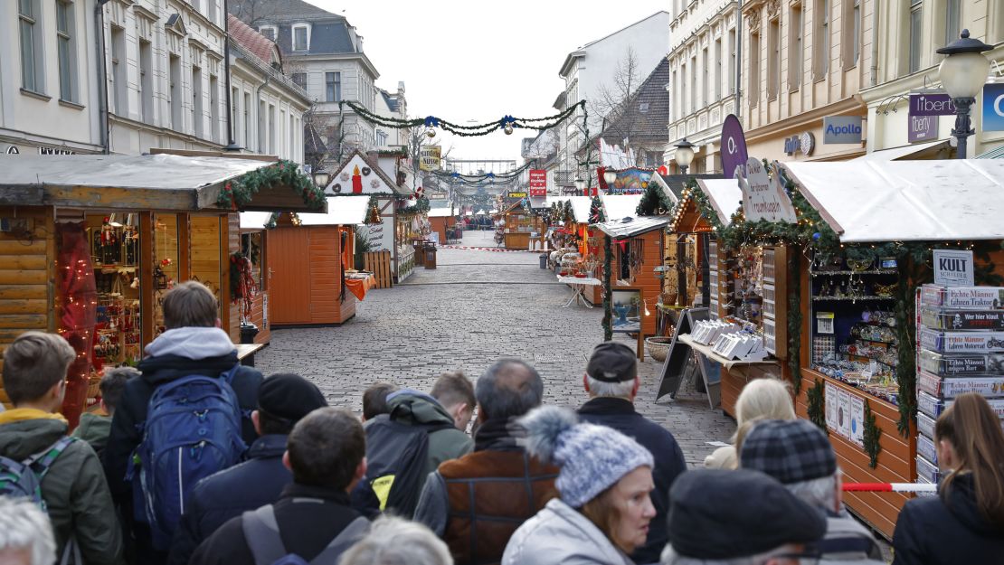 Crowds gather behind a police line after the Potsdam Christmas market was evacuated due to an explosive device on December 1. 