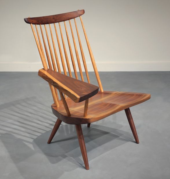 George Nakashima, who designed this lounge chair with writing arm, was also devoted to simplicity, utility and the natural assets of wood in his pieces.