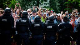 CHARLOTTESVILLE, VA - JULY 08: Counter protestors are held back by riot police as the Ku Klux Klan leaves a staged rally on July 8, 2017 in Charlottesville, Virginia.  The KKK is protesting the planned removal of a statue of General Robert E. Lee, and calling for the protection of Southern Confederate monuments. (Photo by Chet Strange/Getty Images)