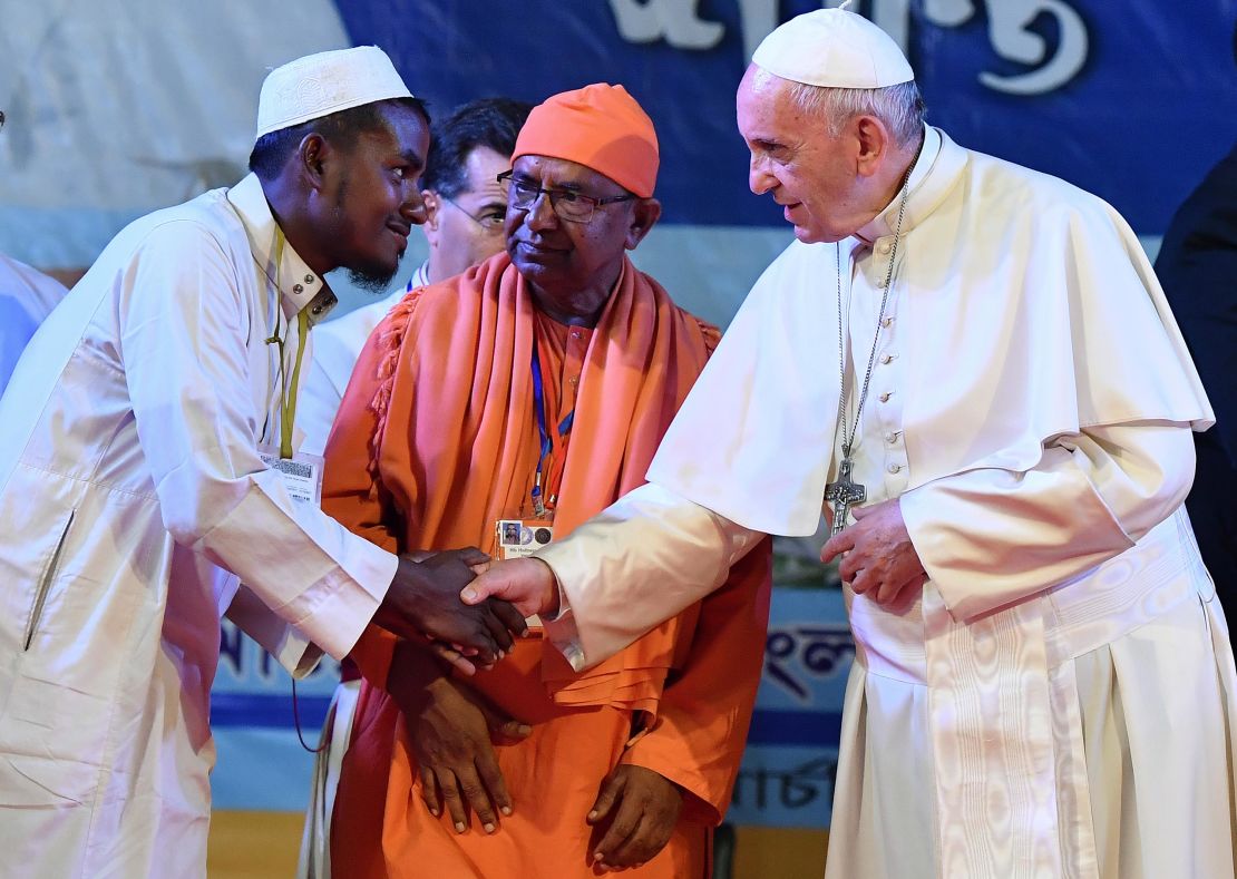 Pope Francis shakes hands with Rohingya refugees during an interreligious and ecumenical meeting for peace on Friday in Dhaka, Bangladesh.