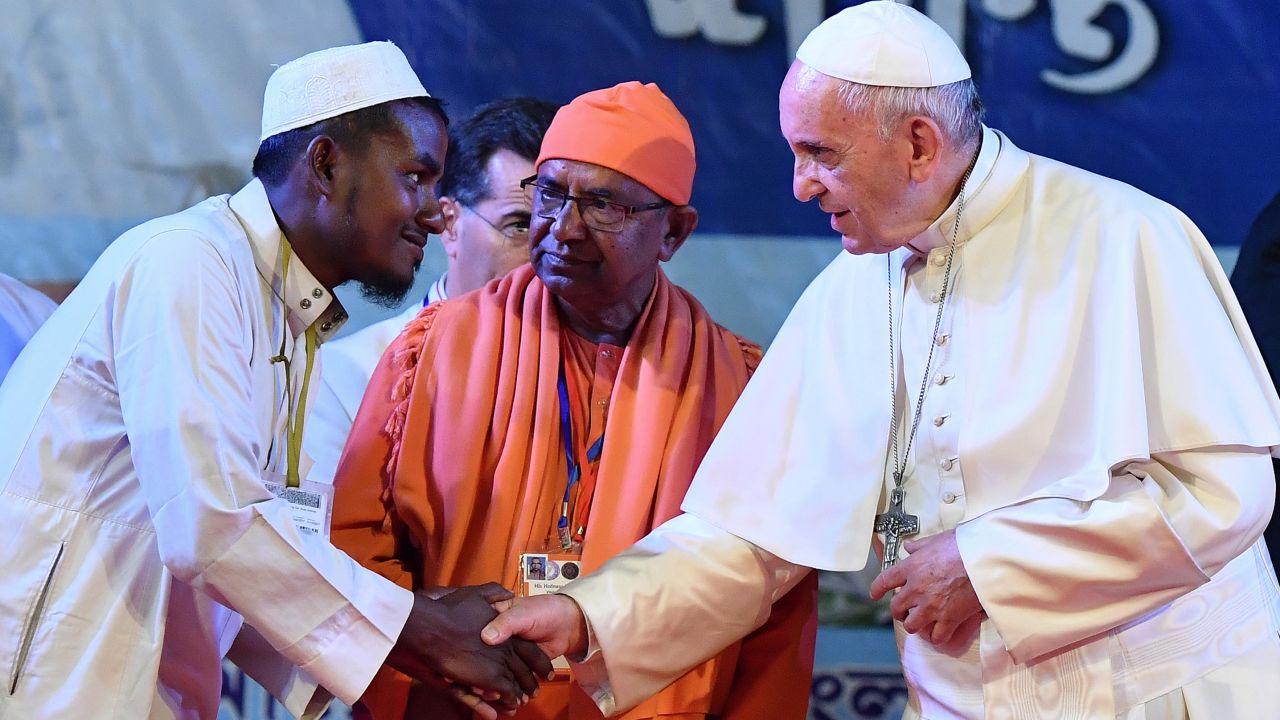 Pope Francis shakes hands with Rohingya refugees during an interreligious and ecumenical meeting for peace on Friday in Dhaka, Bangladesh.
