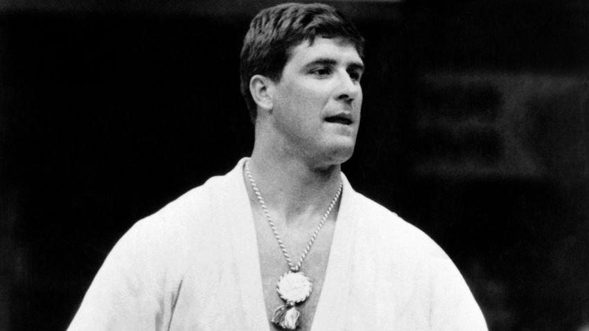 Anton Geesink from Netherlands, poses wearing the gold medal he won in the Judo Open event at the Olympic Games in Tokyo, October 1964.  World champion in 1961 and 1965 the giant (2-metre) Dutchman won the European title for individuals 13 times. / AFP PHOTO / -        (Photo credit should read -/AFP/Getty Images)