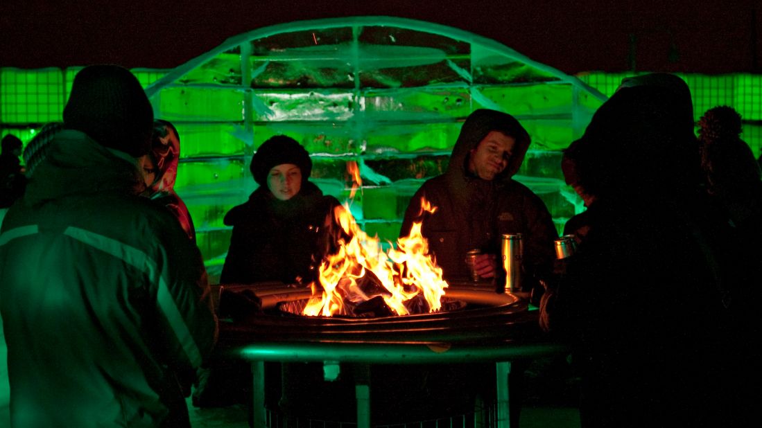 <strong>January in Montreal: </strong>People sit around a fire during Igloofest at Jacques-Cartier Pier in the Old Port of Montreal.