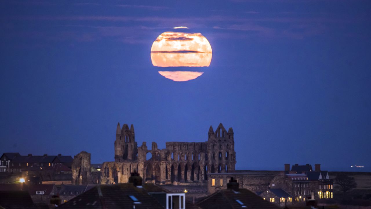 The supermoon rises above Whitby Abbey in Yorkshire, England.