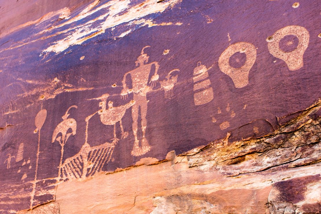 Ancient rock art is pockmarked by bullet holes.