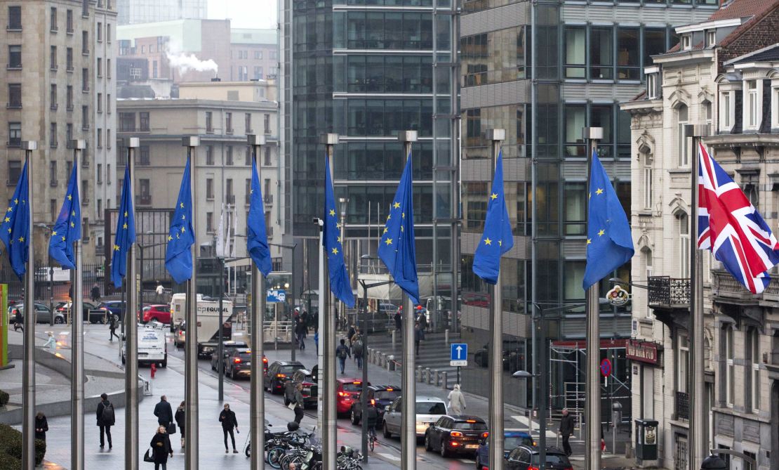 Flags flap in the wind outside the EU headquarters in Brussels on Monday.