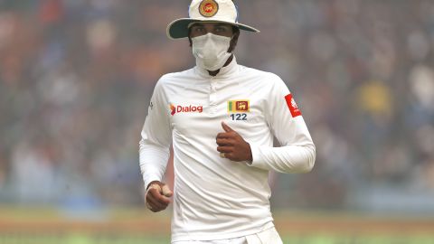 Captain of Sri Lanka's cricket team, Dinesh Chandimal wears an anti-pollution mask during the cricket match in New Delhi on Sunday, December 3. 