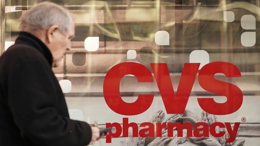 Pedestrians walk past a CVS pharmacy in Washington, DC on December 3, 2017. 
US pharmacy chain CVS has agreed to buy medical insurer Aetna for around $69 billion, according to reports. / AFP PHOTO / MANDEL NGAN        (Photo credit should read MANDEL NGAN/AFP/Getty Images)