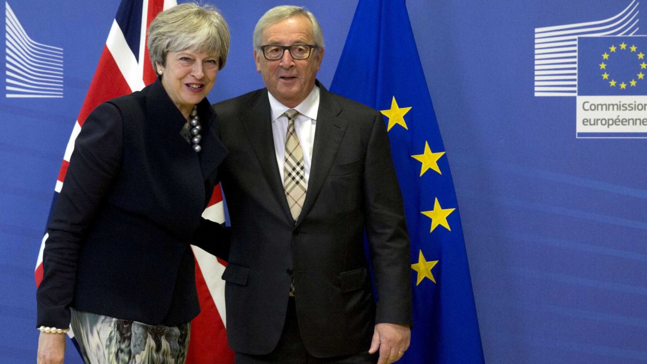 European Commission President Jean-Claude Juncker, right, greets British Prime Minister Theresa May in Brussels.