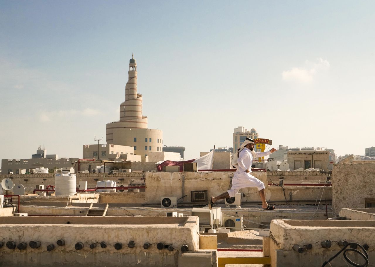 A man jumps on the rooftops of Souq Waqif in Qatar.

