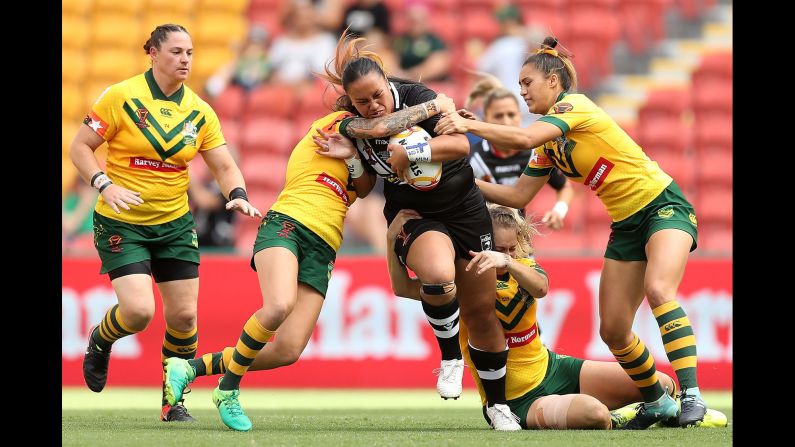Australian rugby players tackle New Zealand's Lilieta Maumau during the final of the Rugby League World Cup on Saturday, December 2. Australia, the tournament host and defending champion, won 23-16.