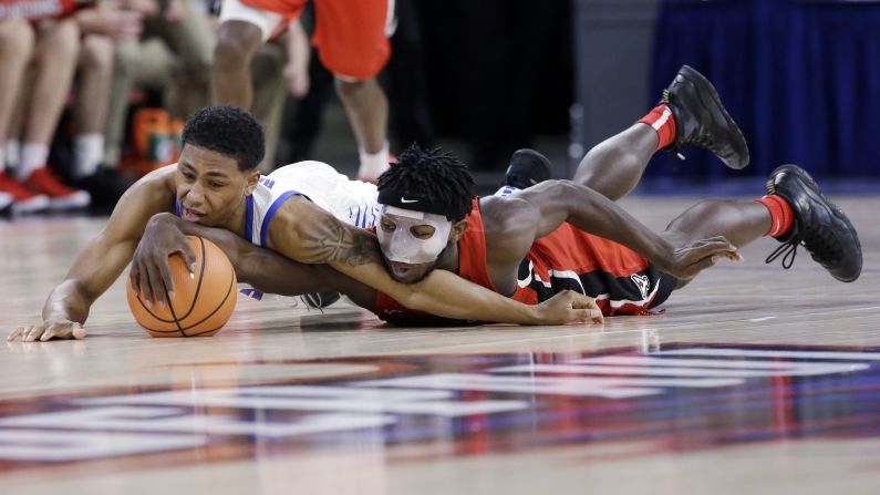 DePaul's Justin Roberts, left, and Youngstown State's Jeremiah Ferguson battle for a loose ball during a college basketball game in Chicago on Saturday, December 2.