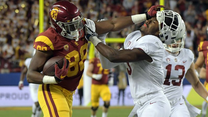 USC tight end Daniel Imatorbhebhe stiff-arms Stanford's Frank Buncom during the Pac-12 championship game on Friday, December 1. USC won 31-28.