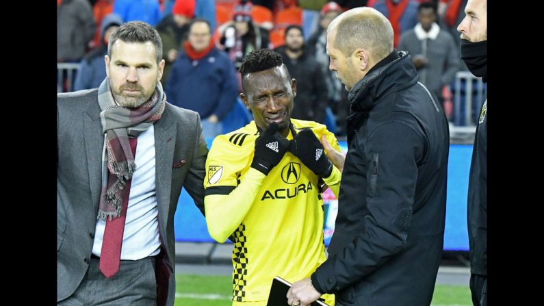 Columbus defender Harrison Afful is consoled by his coach, Gregg Berhalter, right, and Toronto coach Greg Vanney after Toronto won Major League Soccer's Eastern Conference Championship on Wednesday, November 29. Toronto will play Seattle in an MLS Cup rematch on December 10.