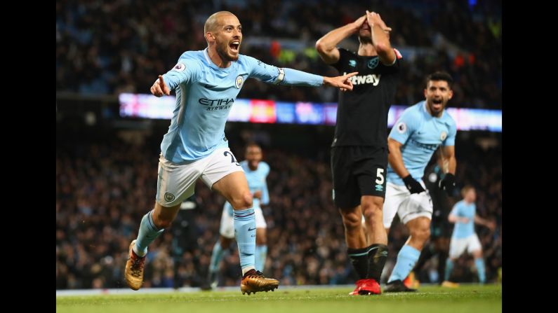 Manchester City's David Silva celebrates his goal -- and West Ham's Pablo Zabaleta covers his face -- during a Premier League match in Manchester, England, on Sunday, December 3. Manchester City won 2-1 to maintain its eight-point lead in the league standings.