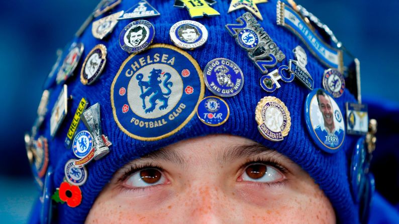 A young Chelsea fan wears a badge-covered hat before a Premier League match in London on Wednesday, November 29.