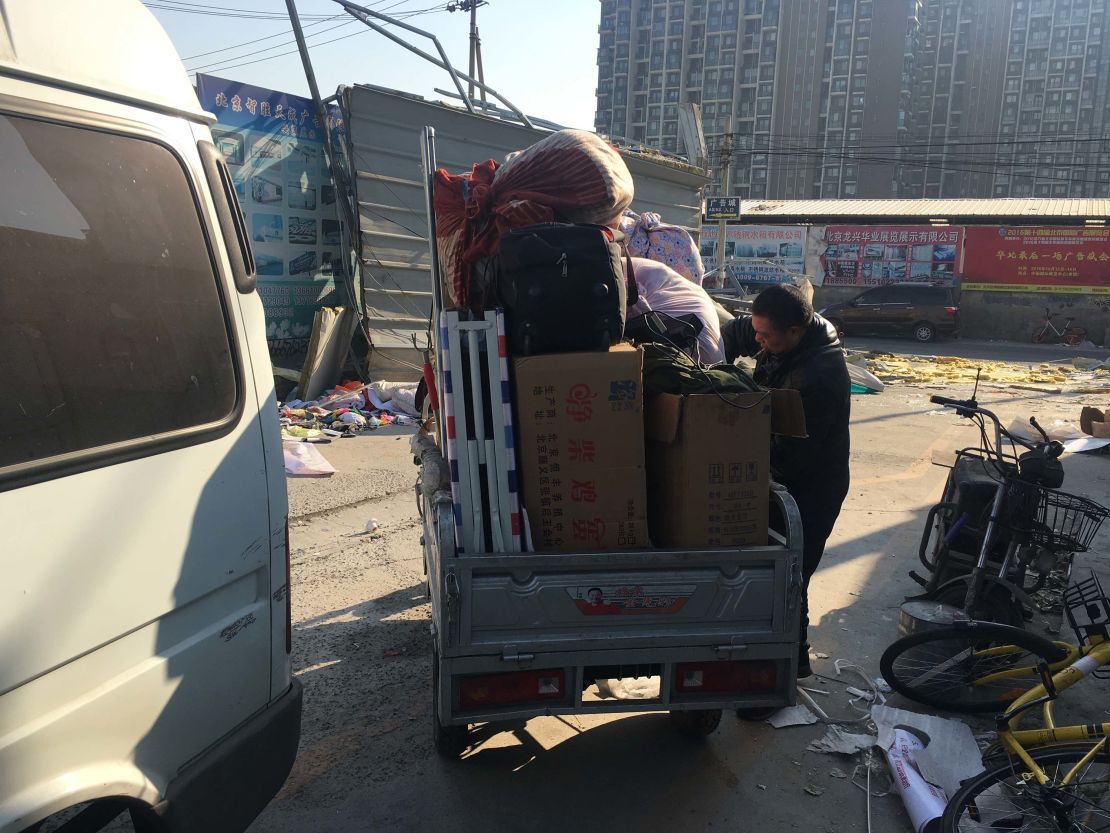 A migrant worker packs his things after being evicted from his rented apartment.