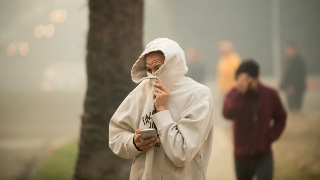 A man watches as a wildfire burns in Ventura on December 5.