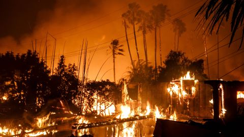 A home is destroyed by a brush fire as Santa Ana Winds help propel the flames to move quickly.