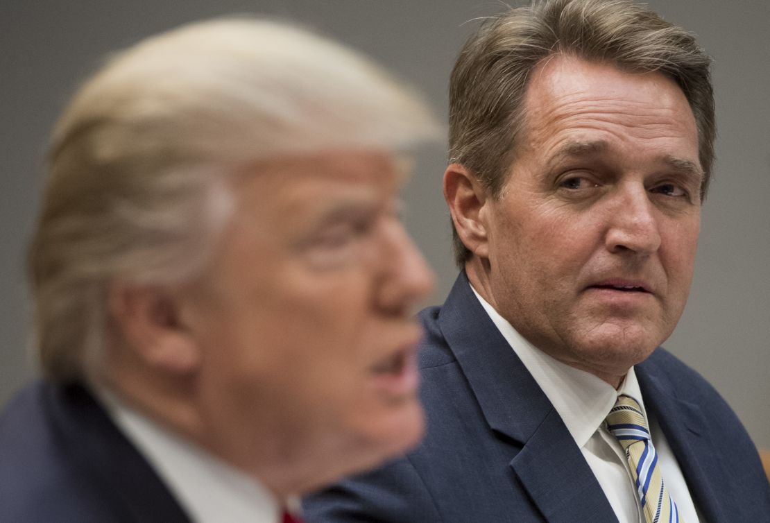 President Donald Trump speaks during a White House lunch meeting with Republican members of the Senate, including Sen. Jeff Flake, right. | Saul Loeb/AFP/Getty