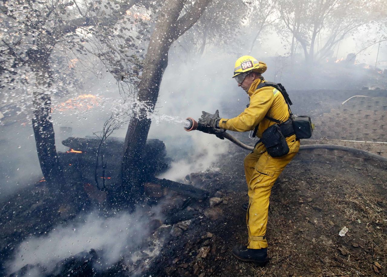 A firefighter battles a blaze in the Lake View Terrace area of Los Angeles on December 5.