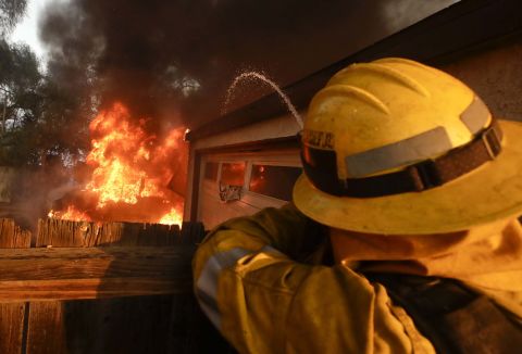 A firefighter sprays water at a burning house in the Lake View Terrace area of Los Angeles on December 5.