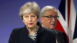 European Commission President Jean-Claude Juncker, right, walks behind British Prime Minister Theresa May prior to addressing a media conference at EU headquarters in Brussels on Monday, Dec. 4, 2017. British Prime Minister Theresa May and EU Commission President Jean-Claude Juncker held a power lunch on Monday, seeking a breakthrough in the Brexit negotiations ahead of a key EU summit the week after. (AP Photo/Virginia Mayo)