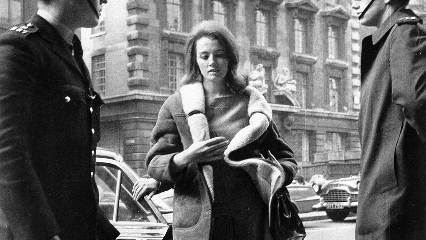 In this file photo dated April 1, 1963, Christine Keeler, 21, arrives at the Old Bailey in London, where her bail was forfeited for her failure to appear earlier as a court witness in a shooting case against her ex-lover. 