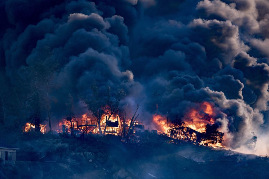 Smoke billows from a burning house in Los Angeles as the Creek Fire moves through the area on December 5.