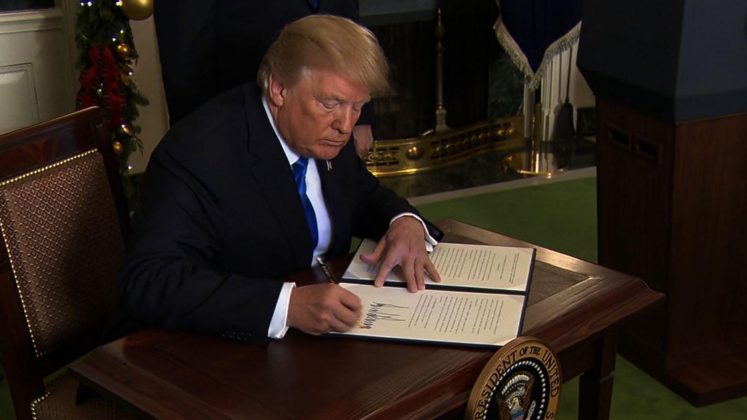 US President Donald Trump photographed signing the US's official recognition of Jerusalem as Israel's capital in this December photo.