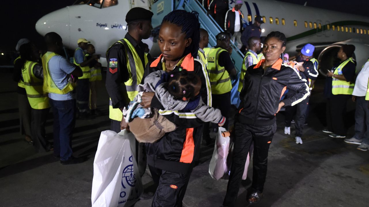 A mother and child return home to Lagos along with 150 other migrants from Libya, on December 5, 2017.

