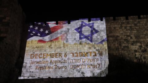 Flags of the United States and Israel are reflected on wallss around the Old City of Jerusalem.