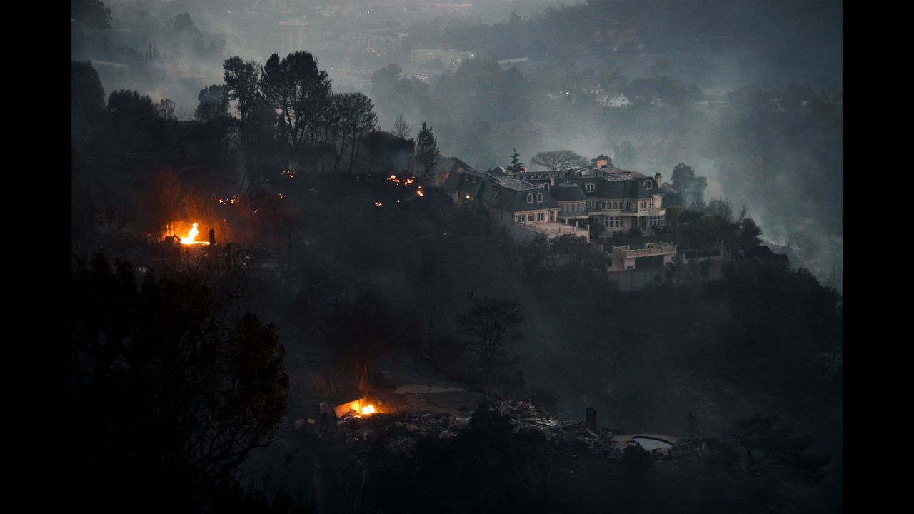 Fires surround a hilltop mansion in Los Angeles on Wednesday, December 6. 