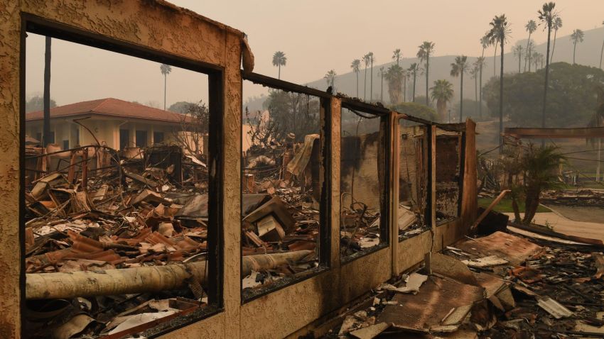 A wall stands in the burnt out Vista del Mar Hospital after the Thomas wildfire swept through Ventura, California on December 6, 2017.
California motorists commuted past a blazing inferno Wednesday as wind-whipped wildfires raged across the Los Angeles region, with flames  triggering the closure of a major freeway and mandatory evacuations in an area dotted with mansions. / AFP PHOTO / Mark RALSTON