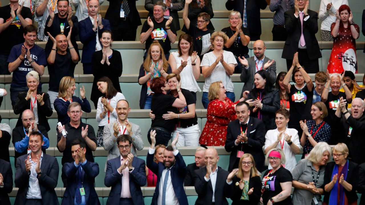 Members of the public, including Christine Forster and partner Virginia Edwards, react from the gallery in Parliament House after legislators passed the same-sex marriage bill on Thursday.