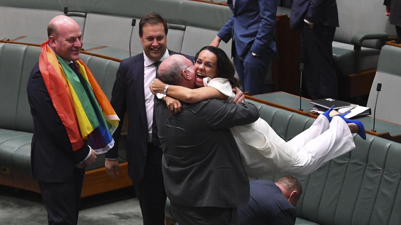 Liberal Member of Parliament Warren Entsch lifts Labor MP Linda Burney as they celebrate the passing of the marriage equality bill at Parliament House in Canberra, Australia, on Thursday.