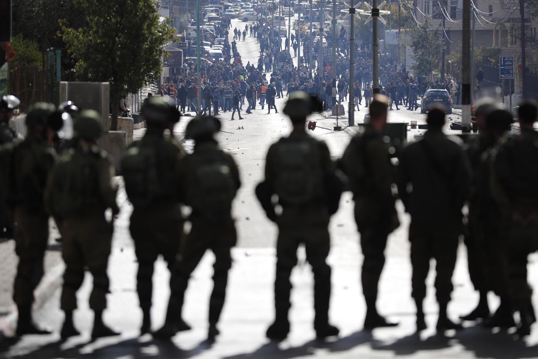 Israeli forces keep watch as Palestinians protest near a checkpoint in 
Bethlehem on Thursday.