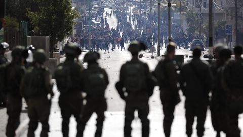 Israeli forces keep watch as Palestinians protest near a checkpoint in
Bethlehem on Thursday.