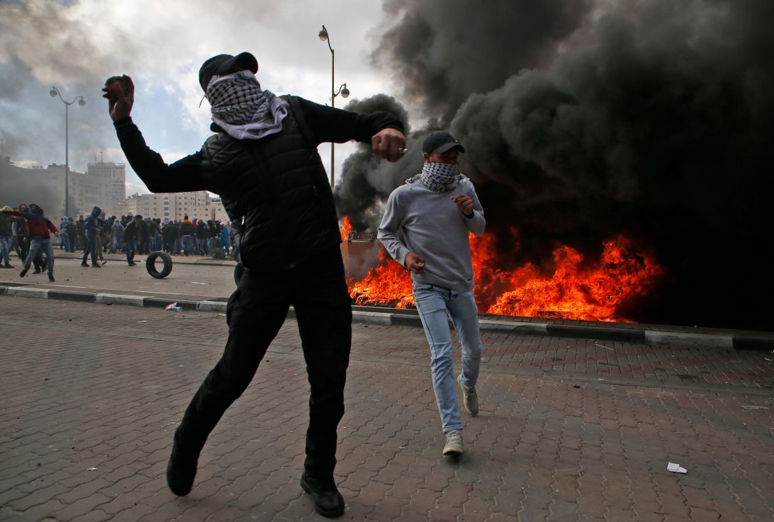 Palestinian demonstrators clash with Israeli security officers during protests in Ramallah on Thursday.