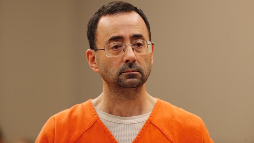 FILE - In this Nov. 22, 2017, file photo, Dr. Larry Nassar, appears in court for a plea hearing in Lansing, Mich. Nassar, an elite Michigan sports doctor who possessed child pornography and assaulted gymnasts, was sentenced Thursday, Dec. 7, 2017,  to 60 years in federal prison in one of three criminal cases that ensure he will never be free again. (AP Photo/Paul Sancya, File)