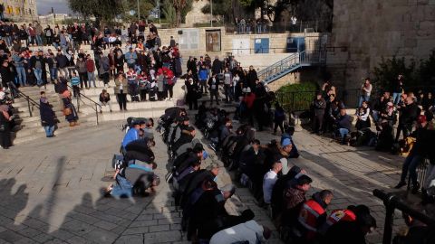 Muslims pray at the Damascus Gate entrance to Jerusalem's Old City on Thursday.