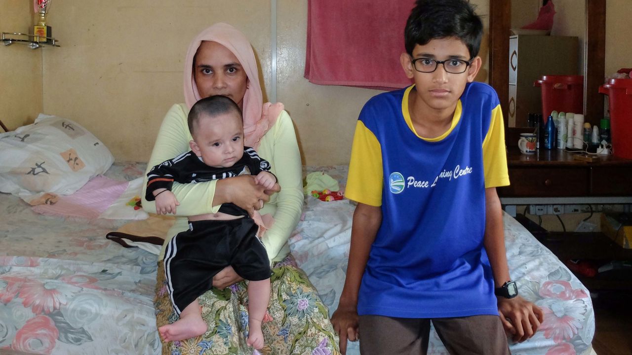 Madam Jubairah Bashir, 34, in her rented room with her son Mohammed Arafat Bashir 13, and her five-month-old infant Mohammed Fahet Bashir. She says she's happy her family is together but would like to return to Myanmar.
