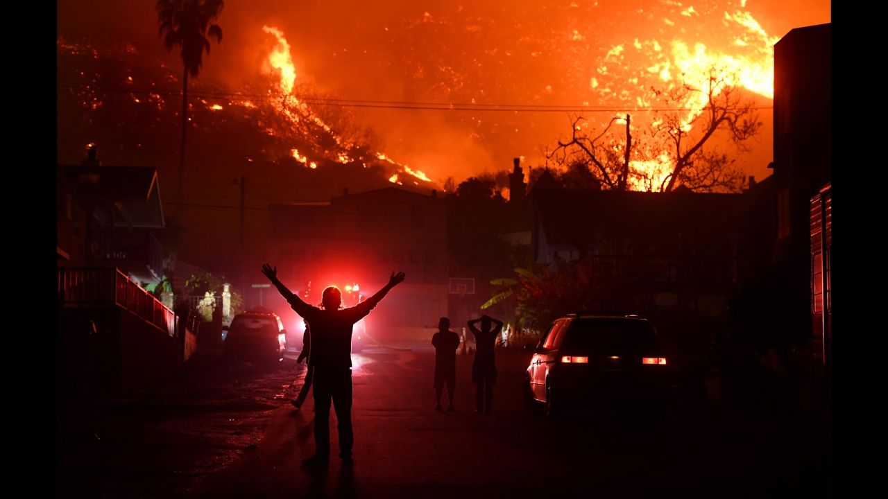 Residents watch the Thomas Fire burn a hillside above La Conchita, California, on December 7.