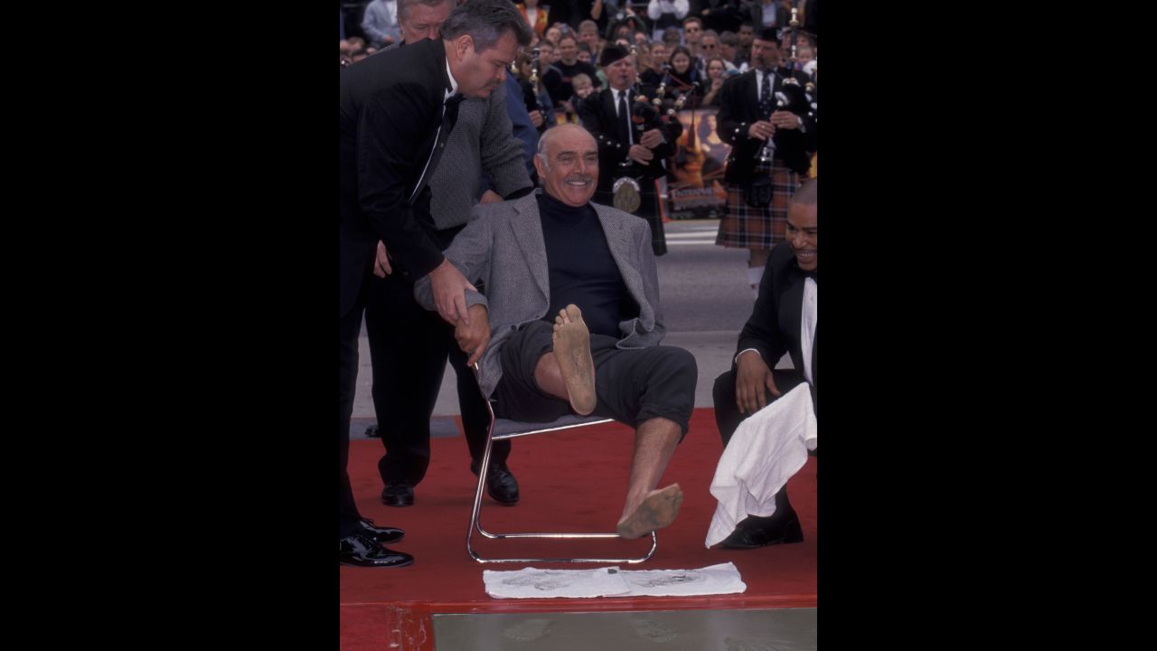 Connery shows his feet to the crowd on the Hollywood Walk of Fame during his Hand and Footprint Ceremony at the Mann Chinese Theater in Hollywood in 1999.