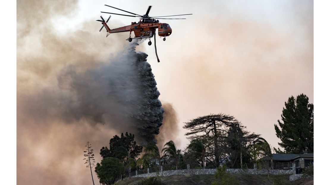 A helicopter makes a water drop over the Creek Fire on December 5, 2017, in Los Angeles.