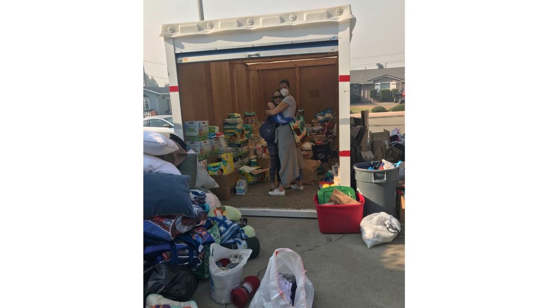 A volunteer hugs a victim of the wildfires.