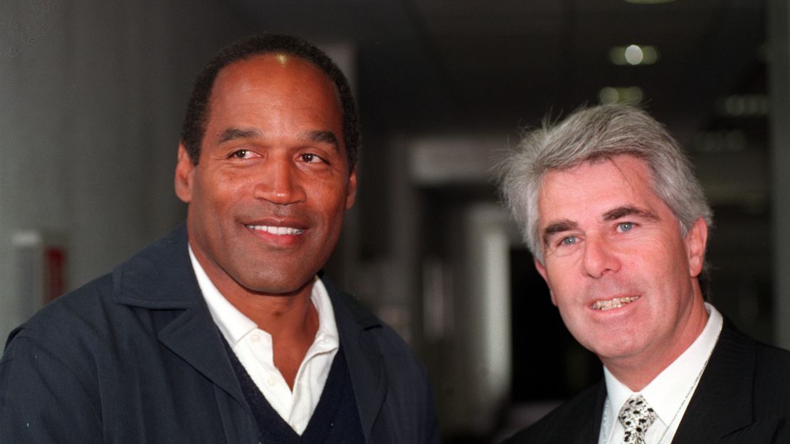 Max Clifford (right) with OJ Simpson at Heathrow airport on his arrival to the United Kingdom in 1996. 